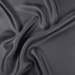 Close-up detail of 22 momme mulberry silk pillowcase fabric texture showing lustrous sheen